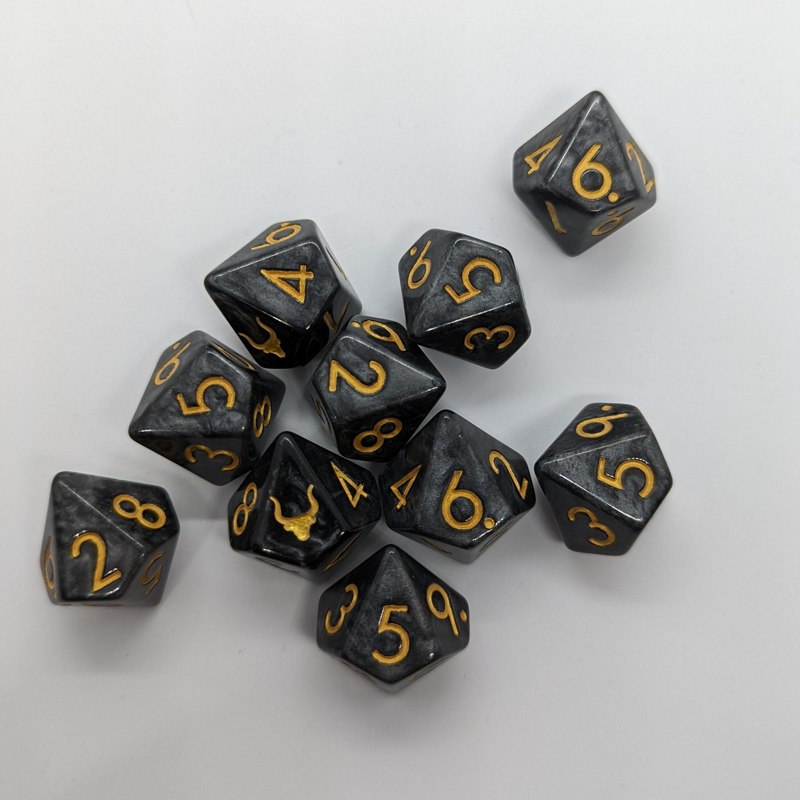 Black 10-sided dice with gold numbers